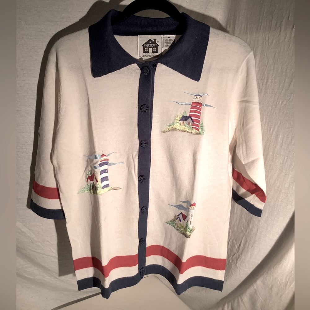 Storybook knit sweater titled “Lighthouse Exclusive”.